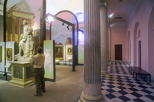 People interacting with displays within the exhibition galleries at the Philadelphia Museum of Art.